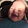 baby, infant, smiling, laughing, bib, closeup, face, cheeks, tongue, eyes_closed, sunlight, shadow, car_seat, portrait, healthy_skin, adorable, happy, head, newborn, indoor