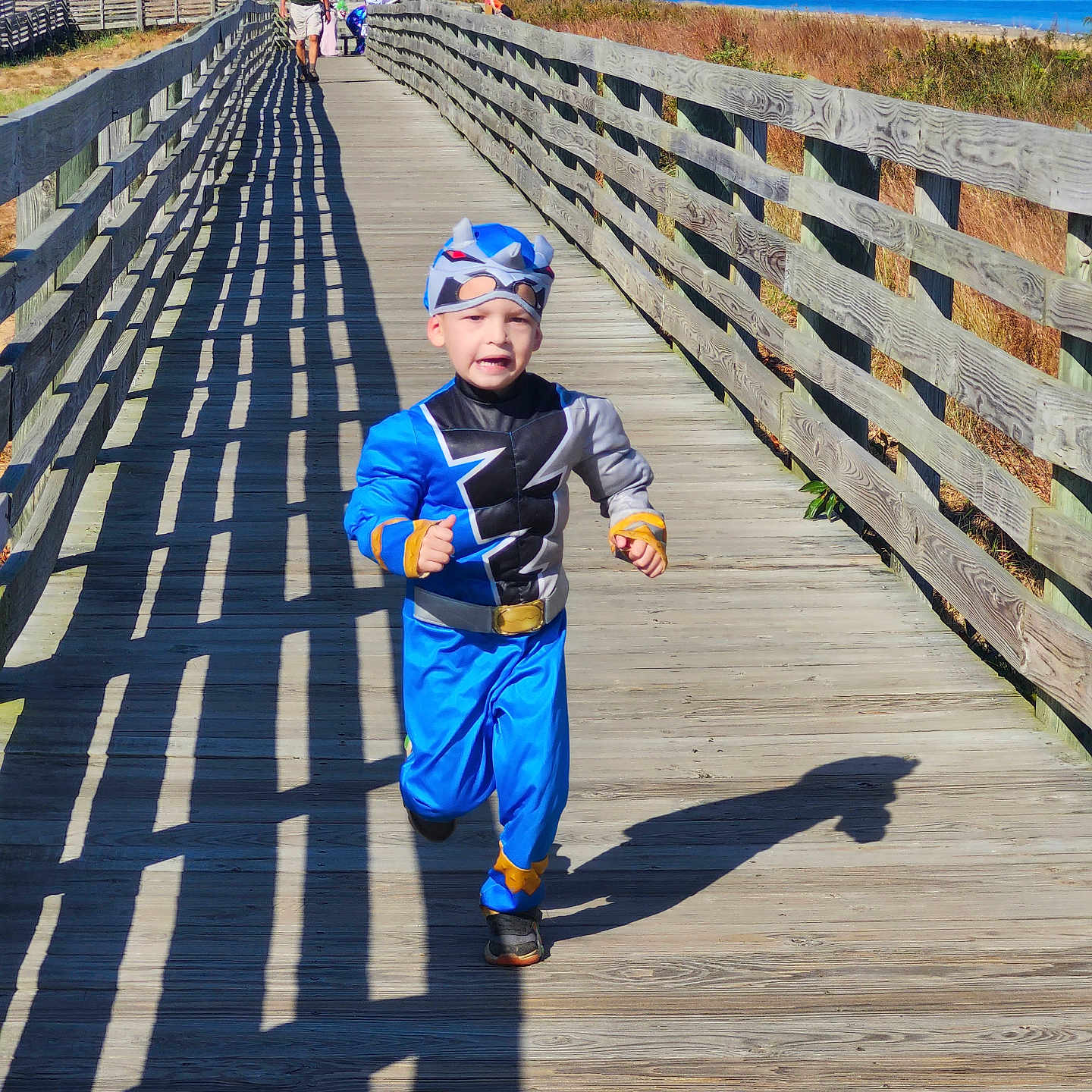 Vincent is registered to the contest to win money with this photo: accessories, bag, belt, boardwalk, boy, bridge, child, clothing, footwear, handbag, hat, male, path, person, pier, shoe, walkway, water, waterfront, wood