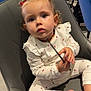Mya a rejoint le concours — aidez-le/la à gagner de superbes lots ! toddler, child, red_bow, pajamas, cherry_pattern, chair, plush_toy, indoor, cafe, people, modern_furniture, curious, sitting, clothing, person, face, baby, foot, hand, jewelry