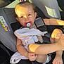 toddler, child, car_seat, pacifier, blanket, sunlight, seatbelt, hair_tie, car_interior, safety, infant, cute, baby, relaxed, portrait, seat, window, skin, person, daylight