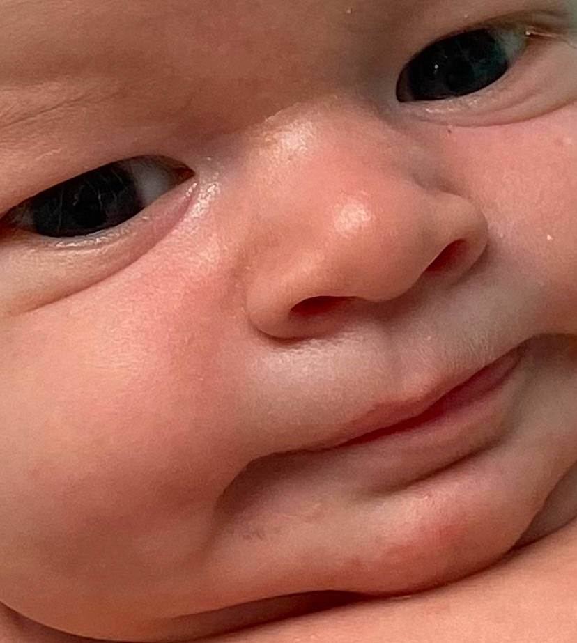 Killian is registered to the contest to win money with this photo: baby, cheek, chin, ear, eyebrow, eyelash, finger, forehead, gesture, human_body, iris, jaw, lip, mouth, no_expression, nose, person, skin, smile, thumb