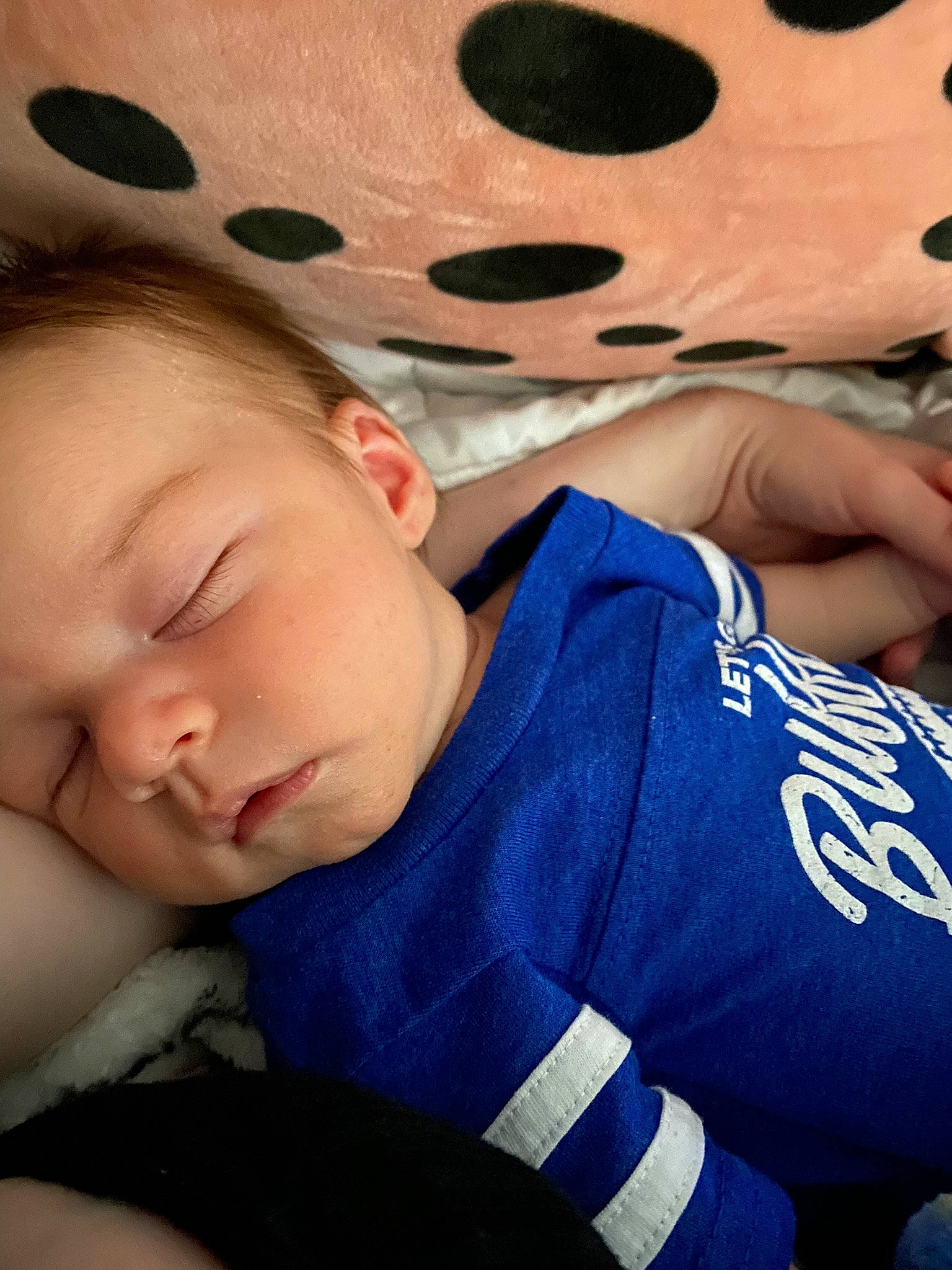 Killian is registered to the contest to win money with this photo: baby, baby_toddler_clothing, bedtime, carmine, cheek, child, comfort, electric_blue, finger, happy, head, linens, mouth, nap, pattern, person, sitting, skin, sleep, toddler