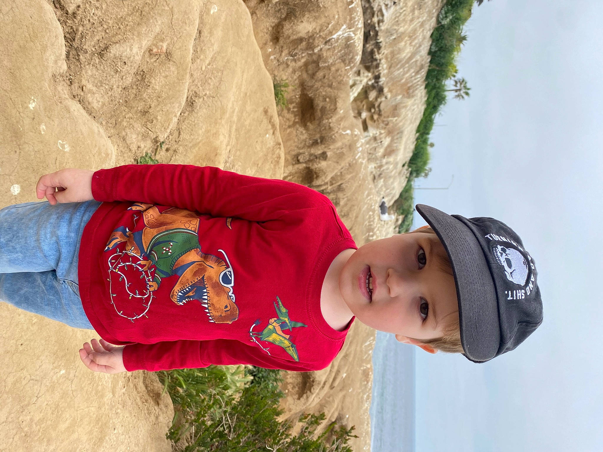 Oliver is registered to the contest to win money with this photo: cap, child, clothing, face, fun, happy, hat, headgear, headwear, landscape, leisure, people_in_nature, person, plant, sky, sleeve, t_shirt, toddler, travel, tree