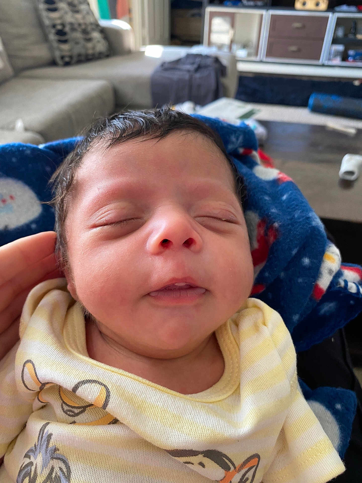 Dakari joined the competition — help win amazing prizes! newborn, baby, sleeping, blanket, hand, face, indoors, couch, furniture, living_room, person, clothing, cozy, cute, peaceful, portrait, infant, home, resting, child