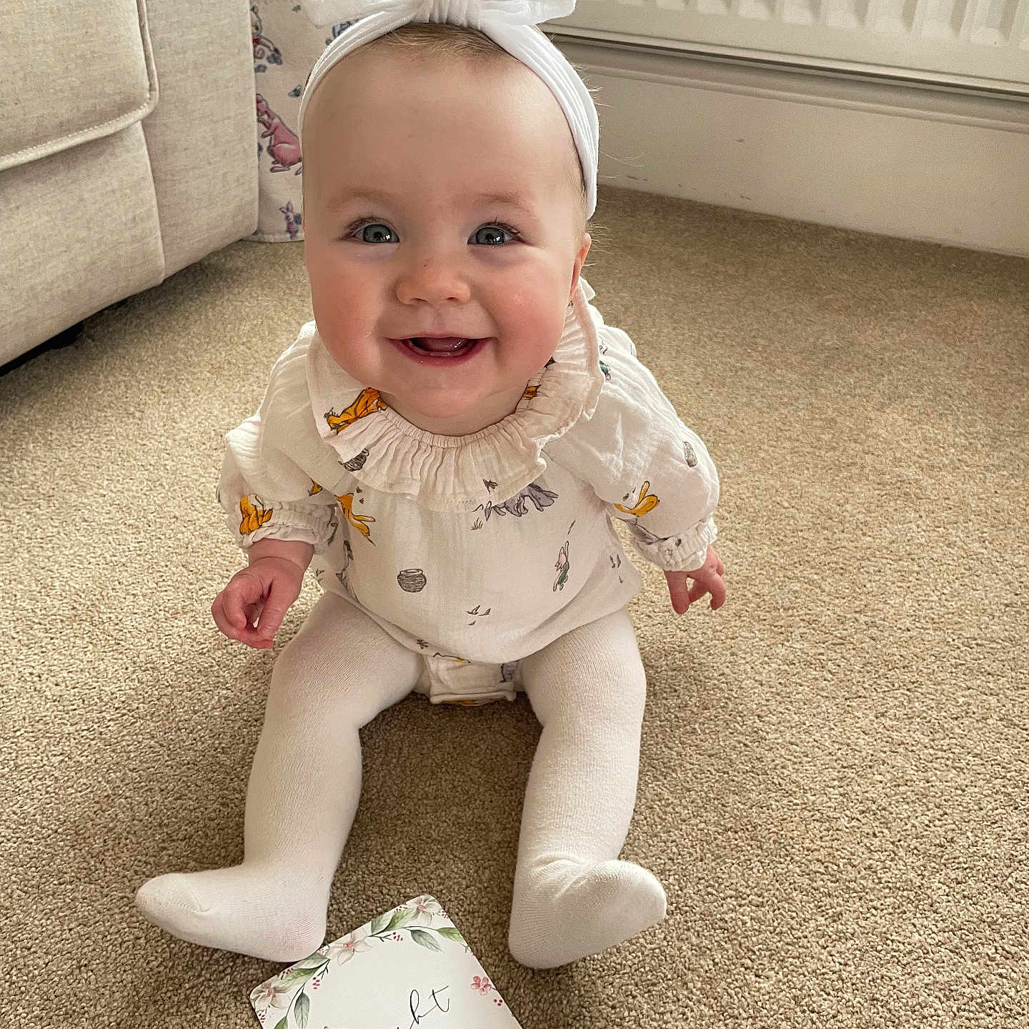 Adeline is registered to the contest to win money with this photo: architecture, baby, babylaughing, clothing, couch, cushion, dress, face, furniture, happy, head, homedecor, hosiery, indoors, pants, person, photography, portrait, sitting, sock