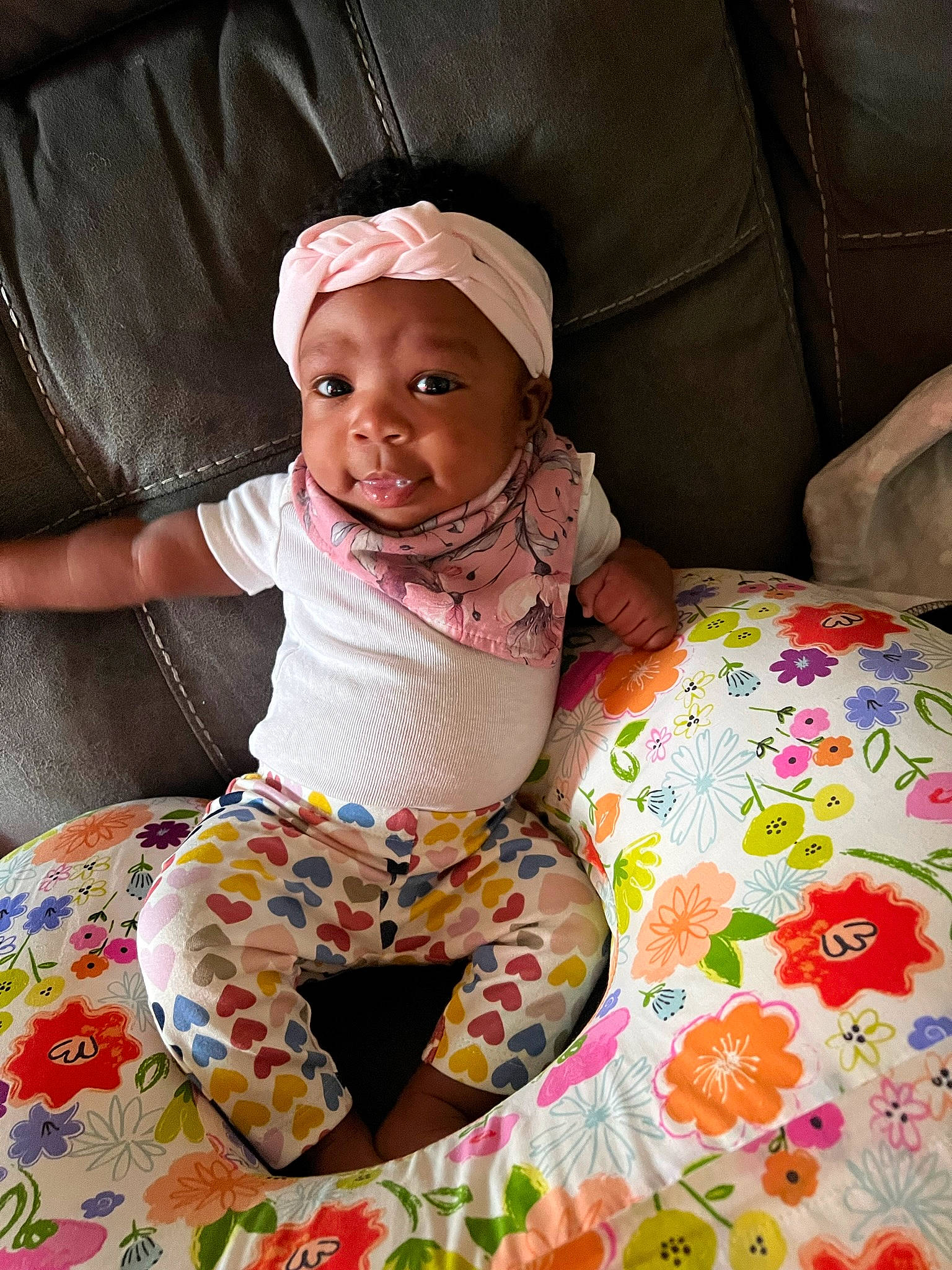 Nova is registered to the contest to win money with this photo: baby, baby_toddler_clothing, cap, child, comfort, facial_expression, fun, happy, headwear, helmet, linens, magenta, pattern, person, pink, play, sitting, skin, sleeve, smile