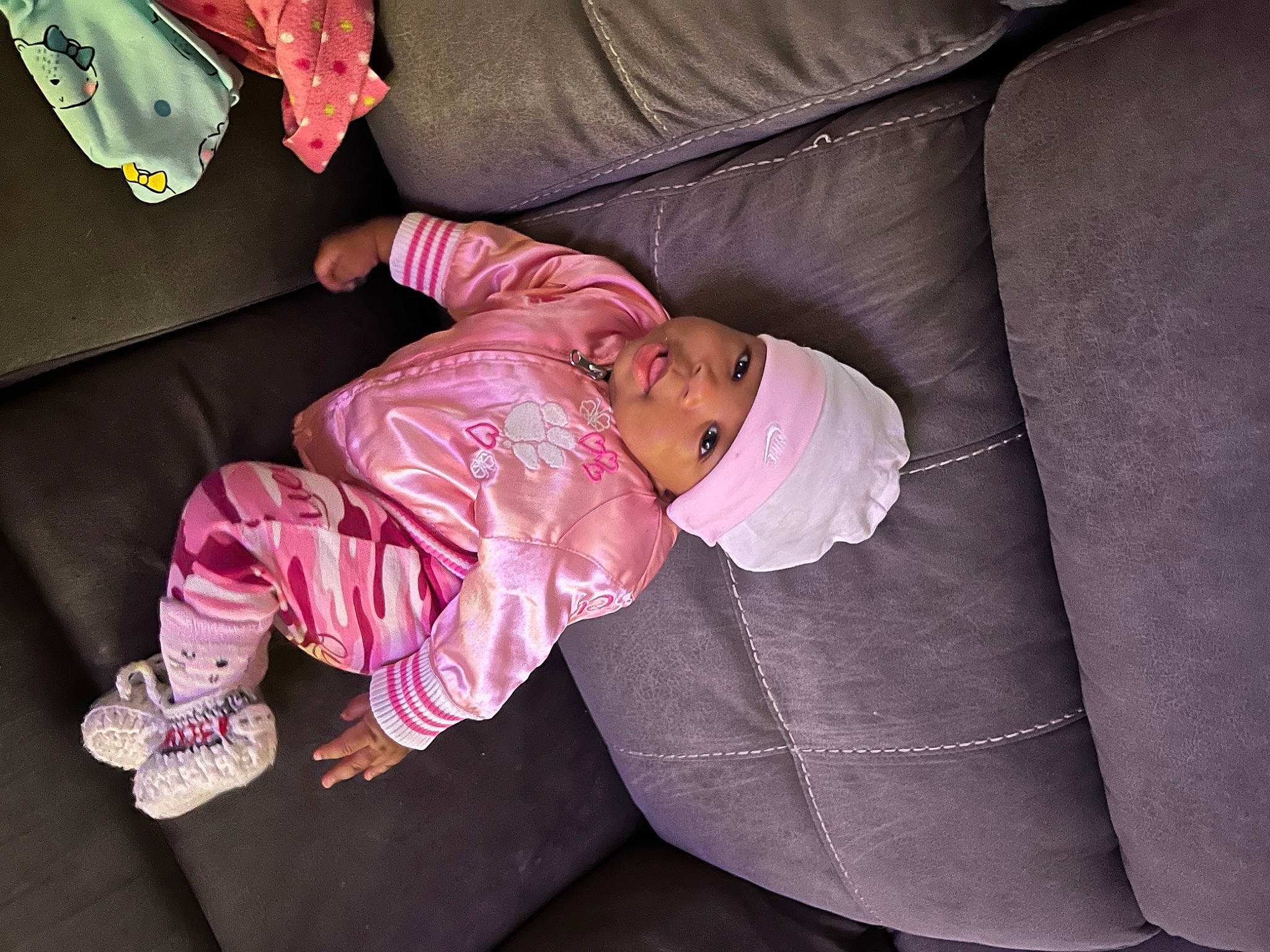 Nova is registered to the contest to win money with this photo: baby, baby_products, baby_toddler_clothing, car_seat, cheek, child, comfort, foot, head, headwear, human_body, lap, linens, magenta, person, pink, room, sitting, sleeve, toddler