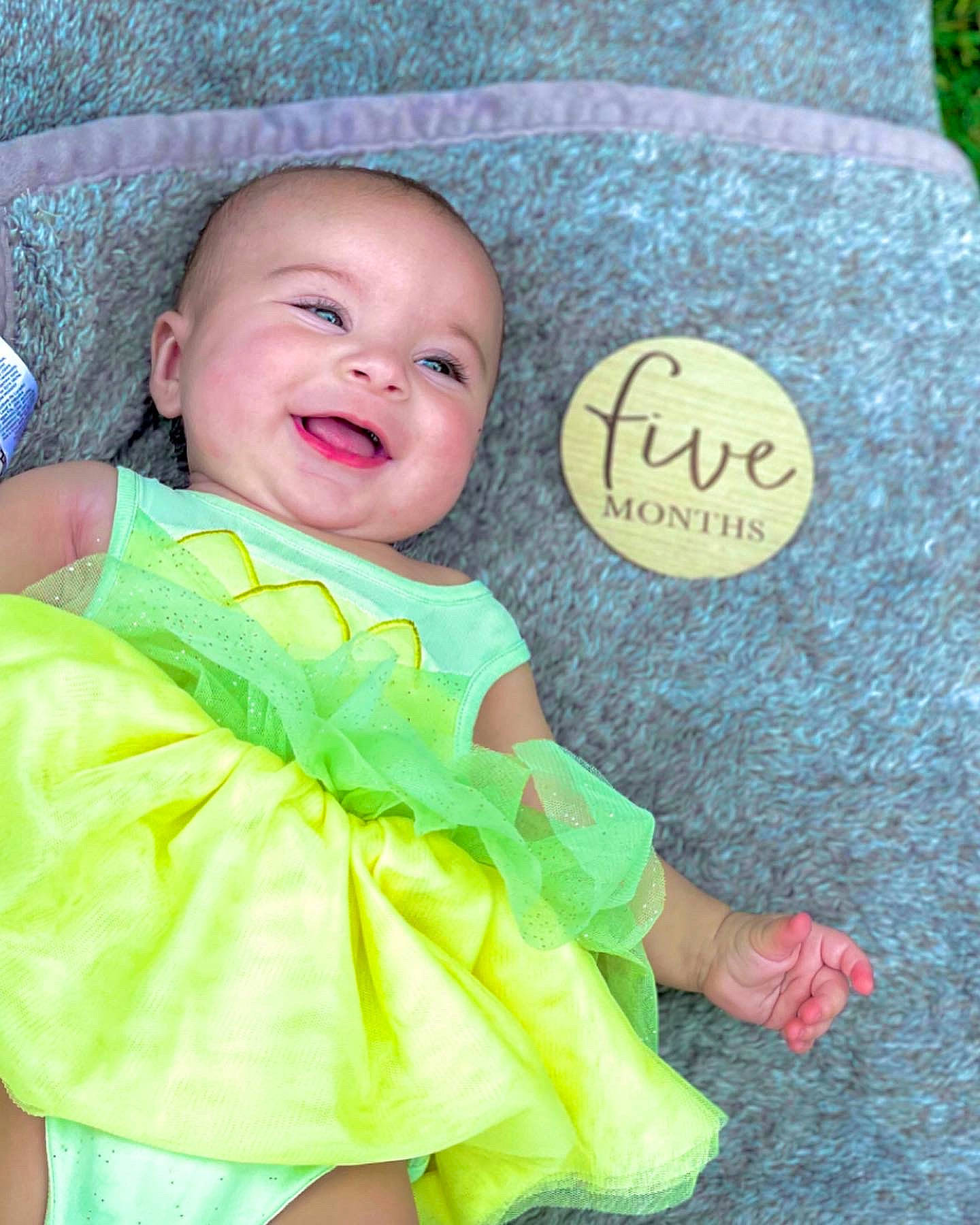 Hensley joined the competition — help win amazing prizes! baby, baby_products, baby_toddler_clothing, child, facial_expression, finger, font, grass, happy, leaf, linens, pattern, person, plant, sitting, skin, sleeve, smile, textile, toddler