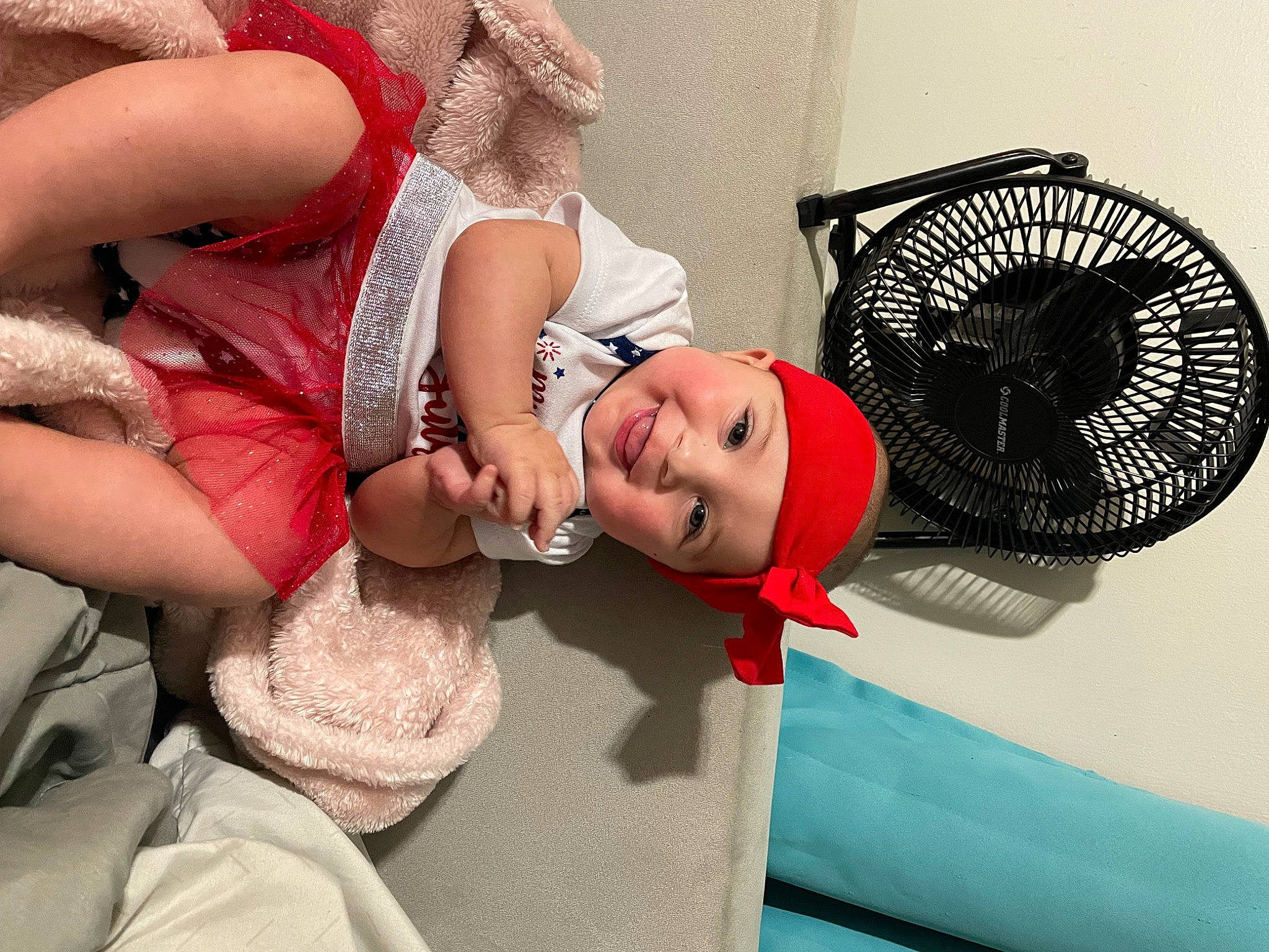Hensley is registered to the contest to win money with this photo: arm, baby, comfort, dress, eyelash, fashion_accessory, fun, hair_accessory, happy, headgear, headwear, human_leg, jewellery, joy, mechanical_fan, nail, person, pink, room, sitting