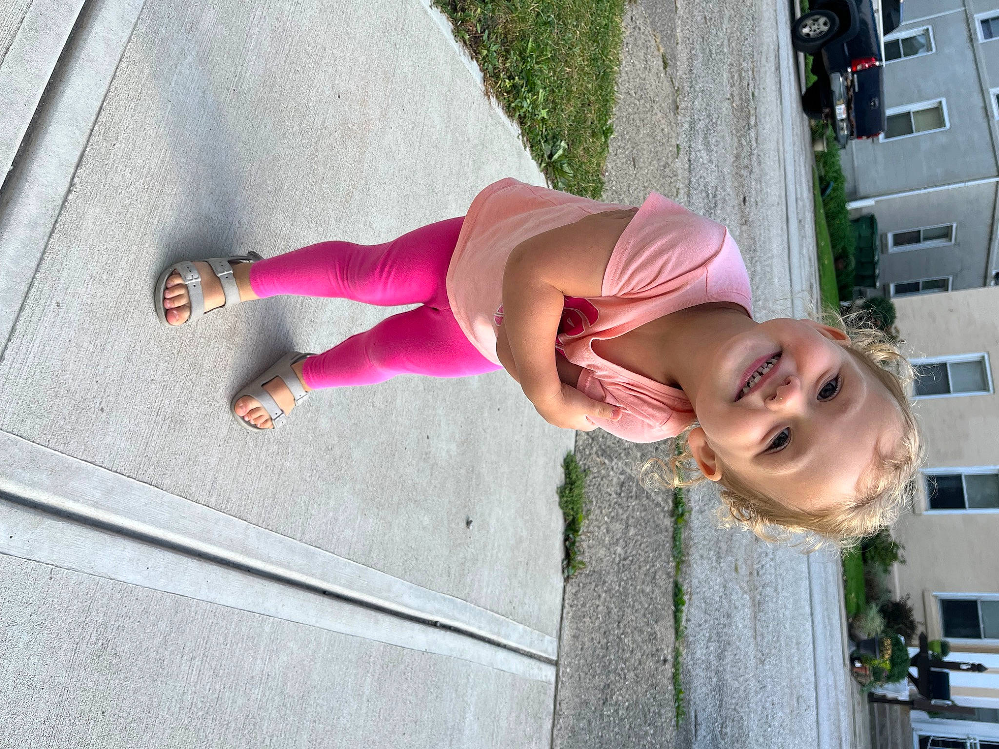 Maggie is registered to the contest to win money with this photo: child, eyewear, facade, fun, happy, human_leg, joy, leisure, magenta, pedestrian, person, pink, plant, shadow, sidewalk, smile, street, sunglasses, thigh, trunk