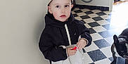 Giovanni a rejoint le concours — aidez-le/la à gagner de superbes lots ! black_and_white, black_jacket, boy, cap, child, curious, dog, doorway, flooring, holding_object, home, indoor, pet, shoes, small_object, standing, tile_floor, vacuum_cleaner, white_jacket, window