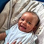 J Pierce is registered to the contest to win money with this photo: baby, smiling, infant, bib, blanket, hand, manicure, clothing, face, cute, happy, lying_down, soft, tender, skin, person, portrait, indoors, comfort, child