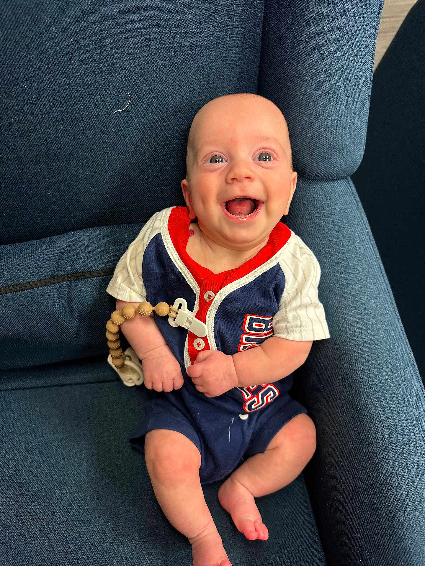 Oliver joined the competition — help win amazing prizes! baby, smiling, blue_chair, infant, clothing, wooden_beads, happy, cute, person, sitting, indoors, portrait, short_sleeves, buttoned_shirt, skin, head, eyes, mouth_open, legs, toes