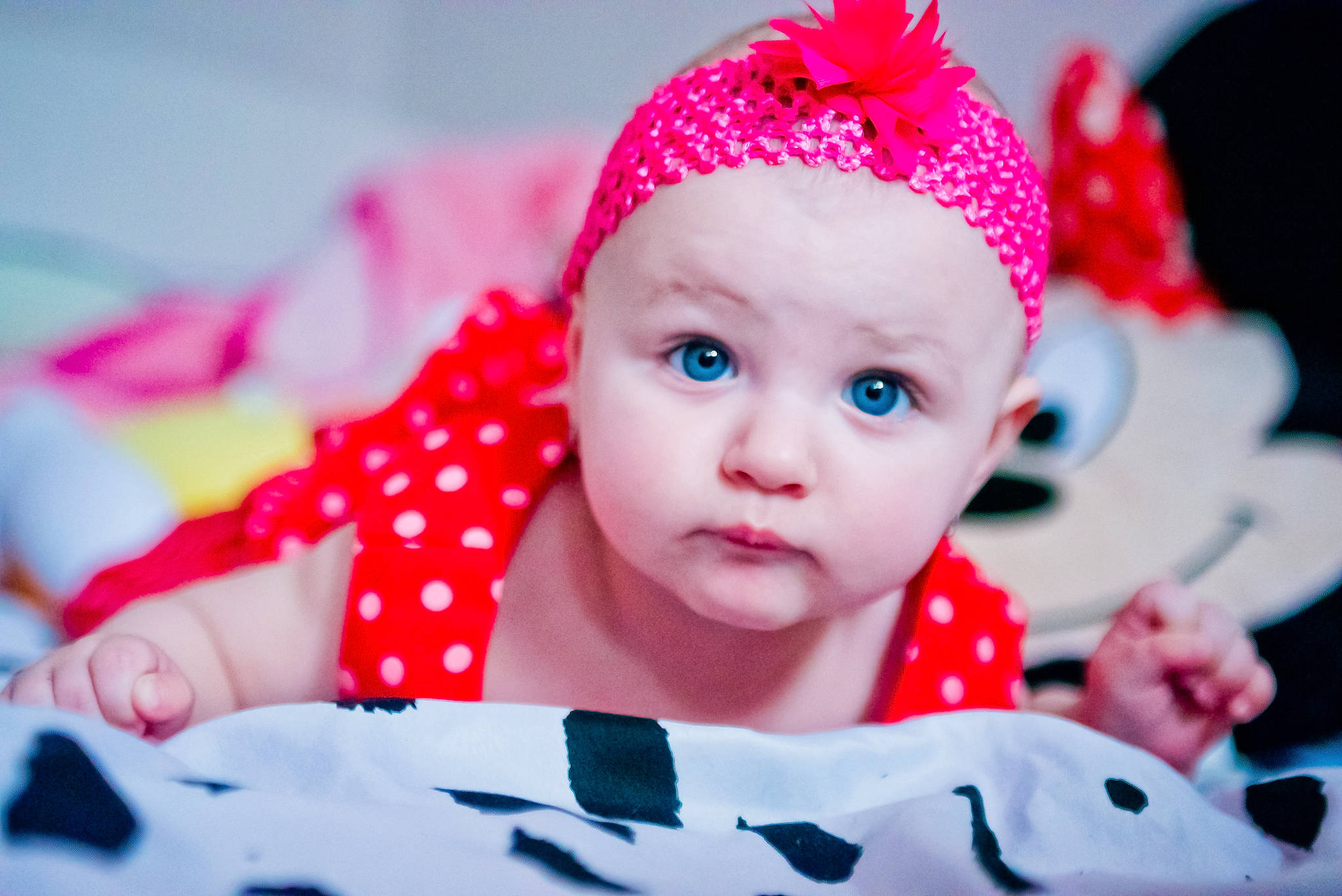 Francesca is registered to the contest to win money with this photo: baby, baby_toddler_clothing, cap, child, design, event, face, fashion_accessory, fun, happy, headband, headpiece, headwear, knit_cap, magenta, pattern, person, pink, red, sleeve