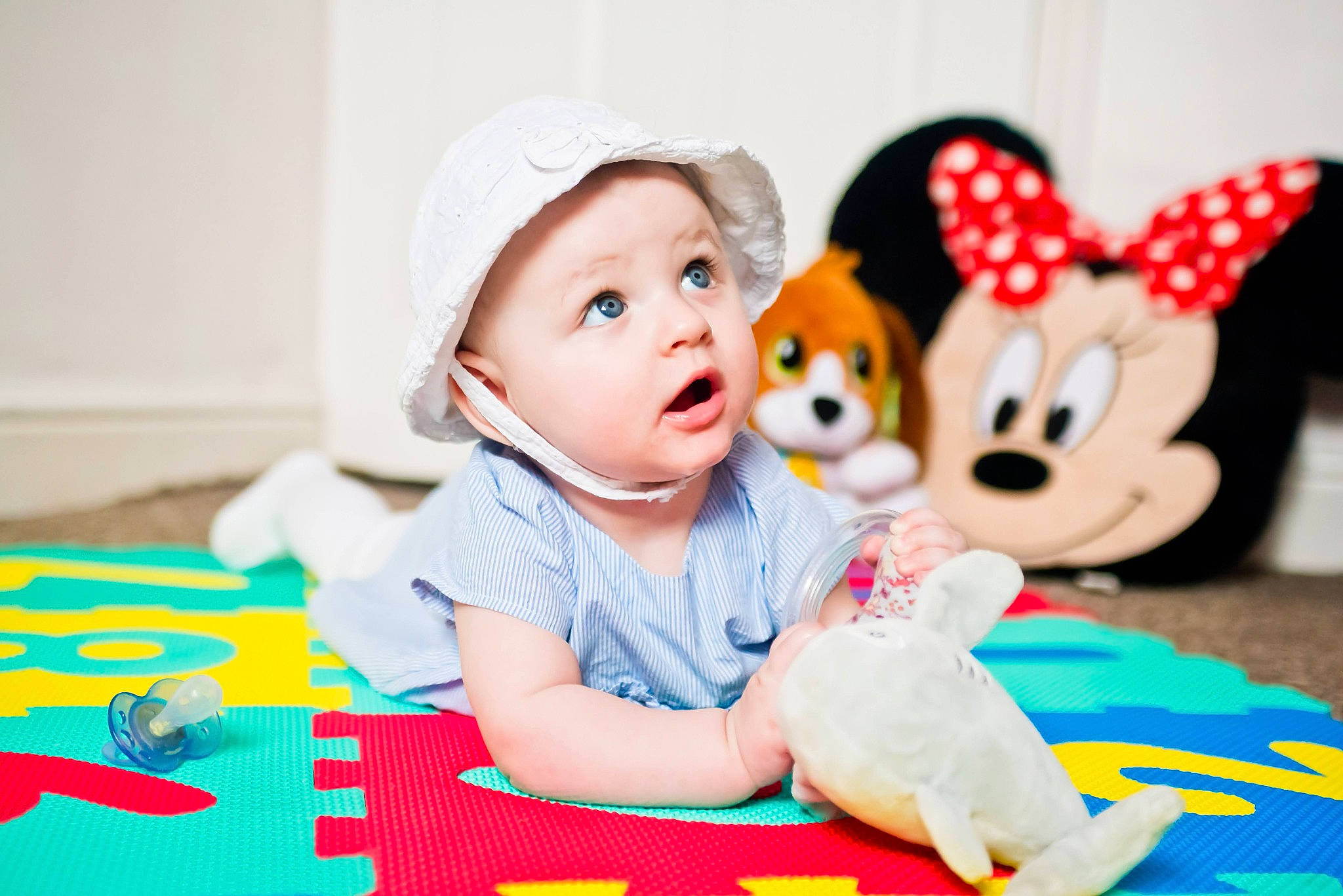 Francesca joined the competition — help win amazing prizes! baby, baby_playing_with_toys, baby_toddler_clothing, cap, child, flooring, fun, happy, hat, headwear, leisure, linens, mammal, people, person, play, recreation, room, sitting, surprise
