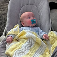Rori joined the competition — help win amazing prizes! baby, baby_seat, blanket, carpet, child, clothing, comfort, cushion, cute, gaze, indoor, infant, knitted, newborn, pacifier, portrait, relaxed, soft, white, yellow