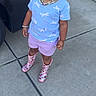 Nevaeh joined the competition — help win amazing prizes! toddler, child, smiling, outdoor, concrete, car, shirt, shorts, rain_boots, necklace, hair_clips, bracelet, garage, standing, happy, portrait, daylight, person, accessories, sidewalk