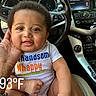 Daylin joined the competition — help win amazing prizes! baby, child, infant, car_interior, steering_wheel, dashboard, clothing, onesie, drool, hand, person, seat, temperature_overlay, happy, cute, smiling, sitting, portrait, indoor, closeup