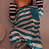 baby, sleeping, onesie, striped_clothing, mittens, plush_slippers, infant, bed, peaceful, cozy, cute, child, soft_lighting, portrait, newborn, sleepwear, indoor, resting, young_child, baby_clothes