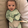 Sebastian is registered to the contest to win money with this photo: baby, infant, smiling, face, onesie, striped_clothing, seat, cushion, sitting, child, young_child, happy, indoor, baby_seat, clothing, person, portrait, cute, cozy, small_hands