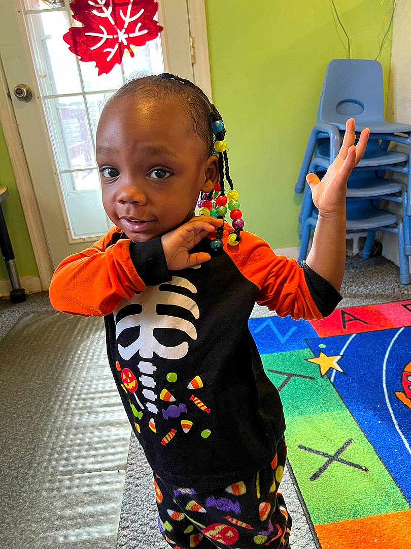 Stephanie joined the competition — help win amazing prizes! adaptation, art, artist, child, cool, face, fashion_design, flooring, fun, happy, head, human_settlement, orange, pattern, person, room, sleeve, standing, t_shirt, toddler