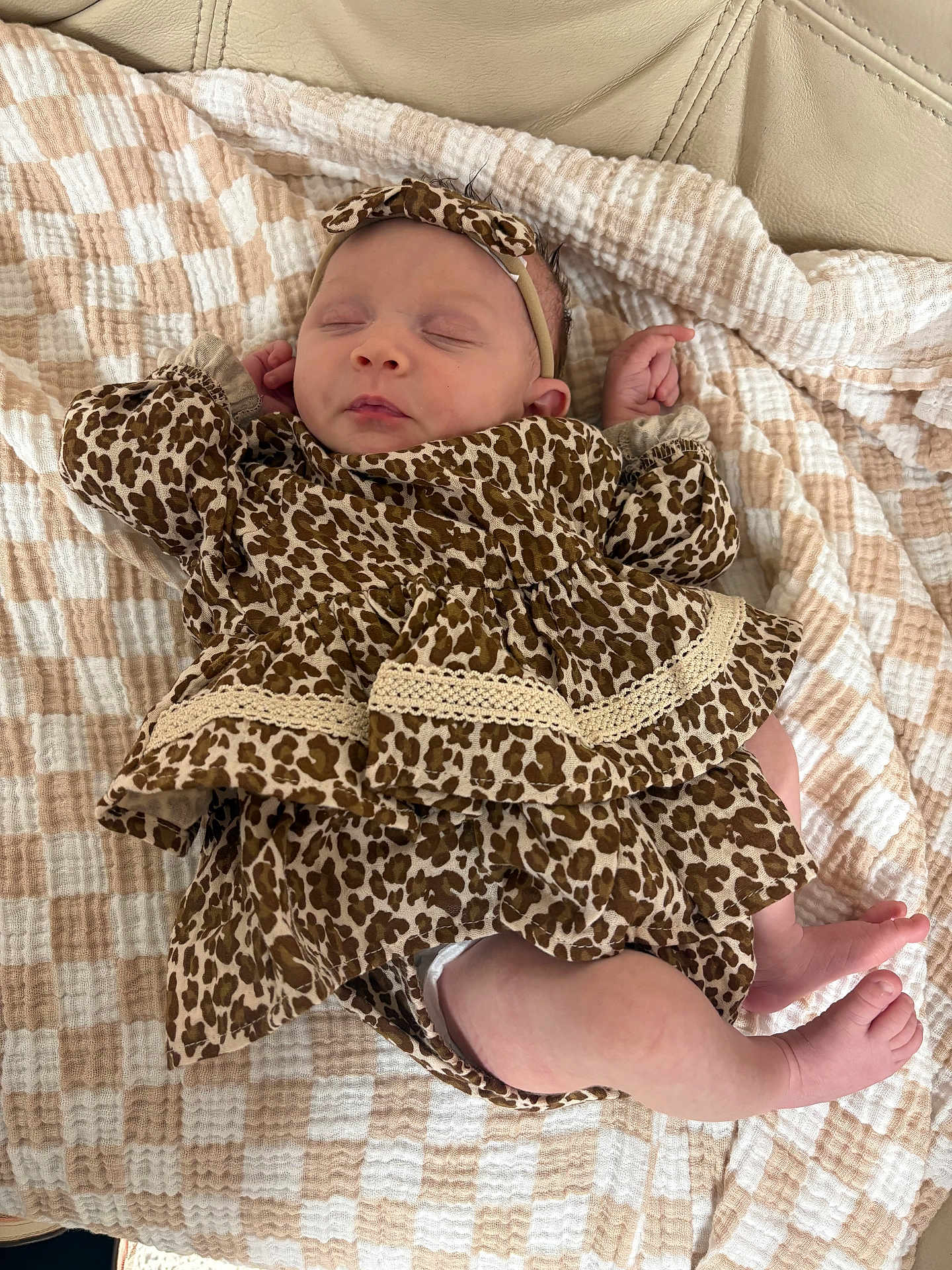 Norah joined the competition — help win amazing prizes! baby, sleeping, leopard_print, headband, blanket, beige, white, soft_texture, clothing, infant, peaceful, resting, cute, patterned, newborn, skin, foot, hand, fabric, leather