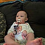 Norah is registered to the contest to win money with this photo: baby, pacifier, couch, blanket, infant, clothing, earring, feet, face, person, indoor, window_blinds, hand, sitting, relaxing, comfort, young_child, casual, home, cute