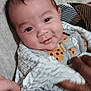 Jayvion is registered to the contest to win money with this photo: baby, bed, blanket, clothing, comfort, cozy, cute, fabric, face, hand, happy, human, infant, person, portrait, smile, soft, striped, touch, wrapped