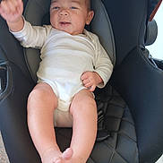 Jayvion joined the competition — help win amazing prizes! baby, black, car_seat, child, comfort, cute, foot, happy, head, indoor, infant, onesie, person, seat, skin, smiling, warning_label, waving_hand, white_clothing, young