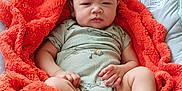 Jayvion joined the competition — help win amazing prizes! baby, blanket, carpet, child, clothing, comfort, cushion, cute, expression, face, foot, hand, indoors, infant, orange, pacifier, person, portrait, resting, seat