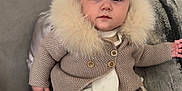 Dream joined the competition — help win amazing prizes! baby, infant, child, bow, headband, fur_collar, knitwear, socks, couch, pillow, gray, cute, portrait, indoor, cozy, fashion, warm_clothing, sitting, expression, face