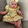 Dream is registered to the contest to win money with this photo: baby, child, infant, headband, bow, floral_dress, couch, sofa, gray, cute, chubby_cheeks, sitting, indoors, comfortable, curious, hands, feet, portrait, person, young_child