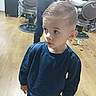 barber, barbershop, big_eyes, blue_sweater, boy, casual_clothing, child, ears, fade_haircut, hair, hair_clippings, haircut, looking_away, mirror, patterned_pants, salon_chair, short_hair, standing, toddler, wooden_floor