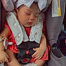 baby, sleeping, car_seat, headband, bow, red_dress, sandals, infant, peaceful, child, seatbelt, cute, small_feet, indoors, resting, safety, adorable, portrait, child_seat, comfort