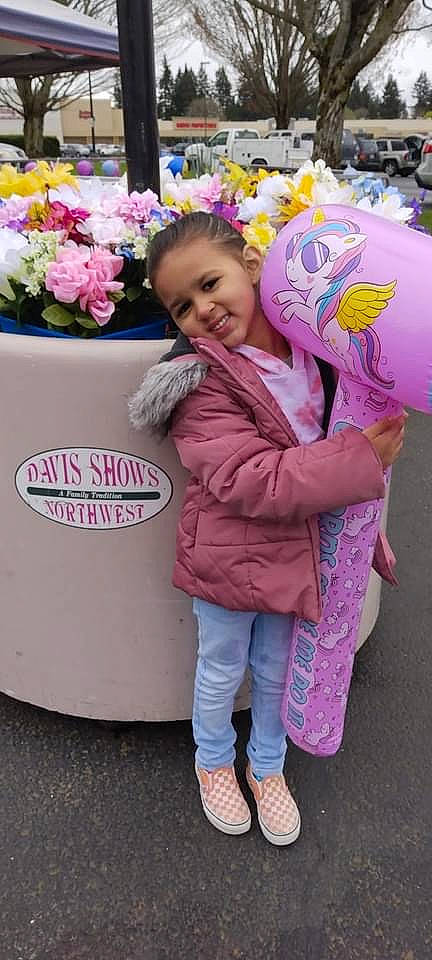 Jade is registered to the contest to win money with this photo: child, cut_flowers, event, flower, flower_arranging, fun, fur, happy, joy, leisure, magenta, person, petal, pink, plant, purple, sandal, smile, sneakers, toddler