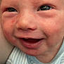baby, newborn, infant, face, close_up, smile, cheeks, eyes, mouth, skin, rosy_cheeks, wrinkled_skin, candid, portrait, onesie, striped_clothing, human, cute, expression, closeup_portrait