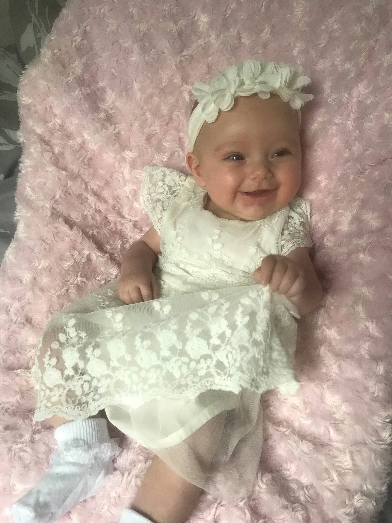 Harriet is registered to the contest to win money with this photo: baby, bonnet, child, dress, hair_accessory, headgear, headpiece, lace, person, pink, product, smile, toddler