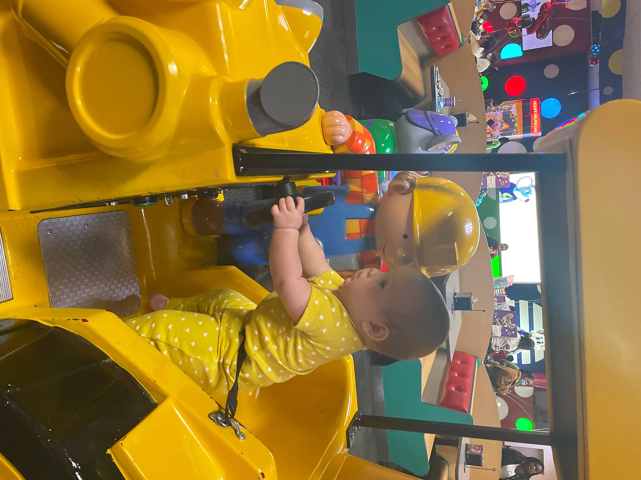 Harland is registered to the contest to win money with this photo: baby, child, engineering, fun, leisure, machine, motor_vehicle, paint, person, personal_protective_equipment, plastic, play, recreation, room, t_shirt, toddler, toy, vehicle, yellow