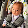 Salomé joined the competition — help win amazing prizes! baby, infant, car_seat, safety_harness, unicorn_pattern, purple_bow, floral_cushion, clothing, child, cute, smile, face, person, seatbelt, restraint, indoors, young_child, head_support, fabric, closeup