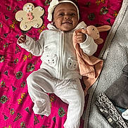 Djena participe au concours pour gagner de l'argent avec cette photo : baby, infant, smiling, white_clothing, headband, toy, stuffed_animal, blanket, pink, patterned, milestone, 3_month, lying_down, cute, child, happy, soft_toy, fabric, indoor, portrait