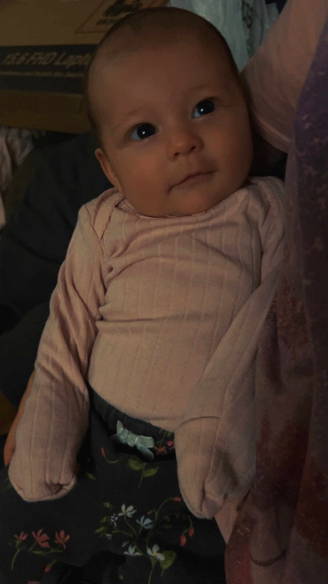Joanna is registered to the contest to win money with this photo: baby, child, infant, pink_sweater, floral_pants, cute, face, eyes, portrait, cozy, indoor, person, young_child, clothing, expression, looking_up, sitting, warm, soft_light, curious
