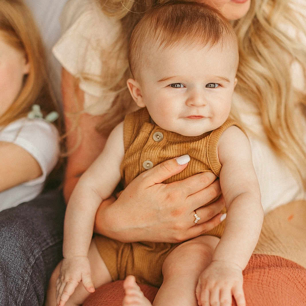 Deacon is registered to the contest to win money with this photo: accessories, baby, bodypart, clothing, face, finger, glasses, hand, happy, head, hugging, jewelry, newborn, pants, people, person, photography, portrait, ring, smile