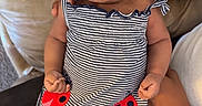 Zuri is registered to the contest to win money with this photo: adult, arms, baby, child, closeup, couch, dress, fashion, indoors, infant, ladybug, nap, peaceful, pillow, pink_socks, portrait, seated, sleeping, socks, striped_outfit