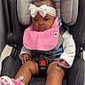 baby, infant, child, car_seat, bow, headband, bib, pink, sneakers, polka_dots, sitting, portrait, face, indoors, harness, stroller, clothing, fashion, cute, photograph