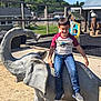Damon is registered to the contest to win money with this photo: background, boy, child, concrete, daytime, elephant, fence, greenery, happy, jeans, outdoor, play, playground, recreation, sand, smiling, sneakers, statue, sunny, tshirt