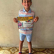 Damon joined the competition — help win amazing prizes! achievement, award, boy, celebration, certificate, child, clothing, floor, happy, indoor, person, red_socks, shirt, shorts, smile, socks, spiderman, standing, tiled_floor, wall