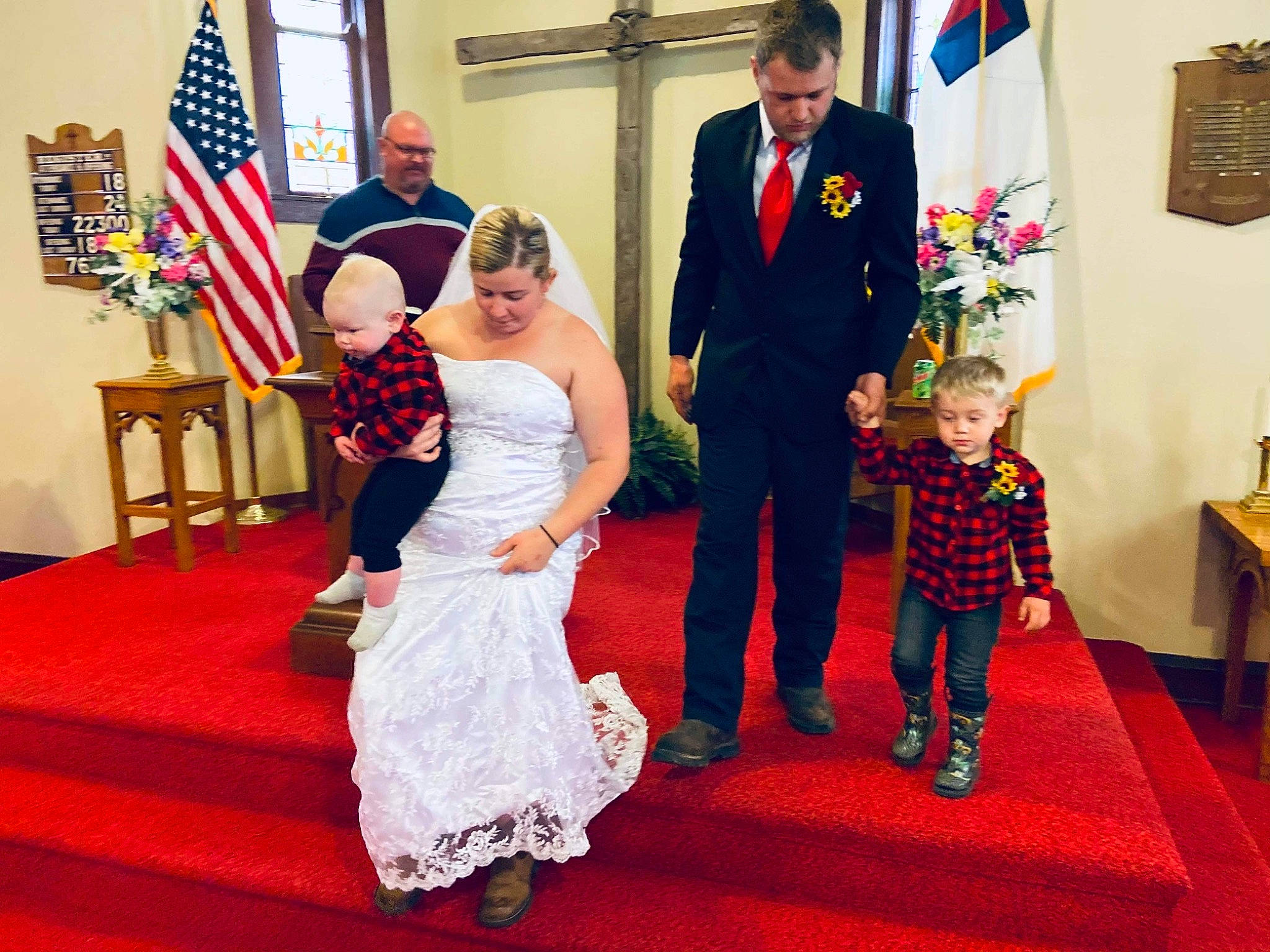 Dalton Jr is registered to the contest to win money with this photo: bridal_clothing, chair, child, dress, event, fashion, flag, flooring, formal_wear, fun, gown, happy, person, red, smile, standing, suit, tie, toddler, trousers