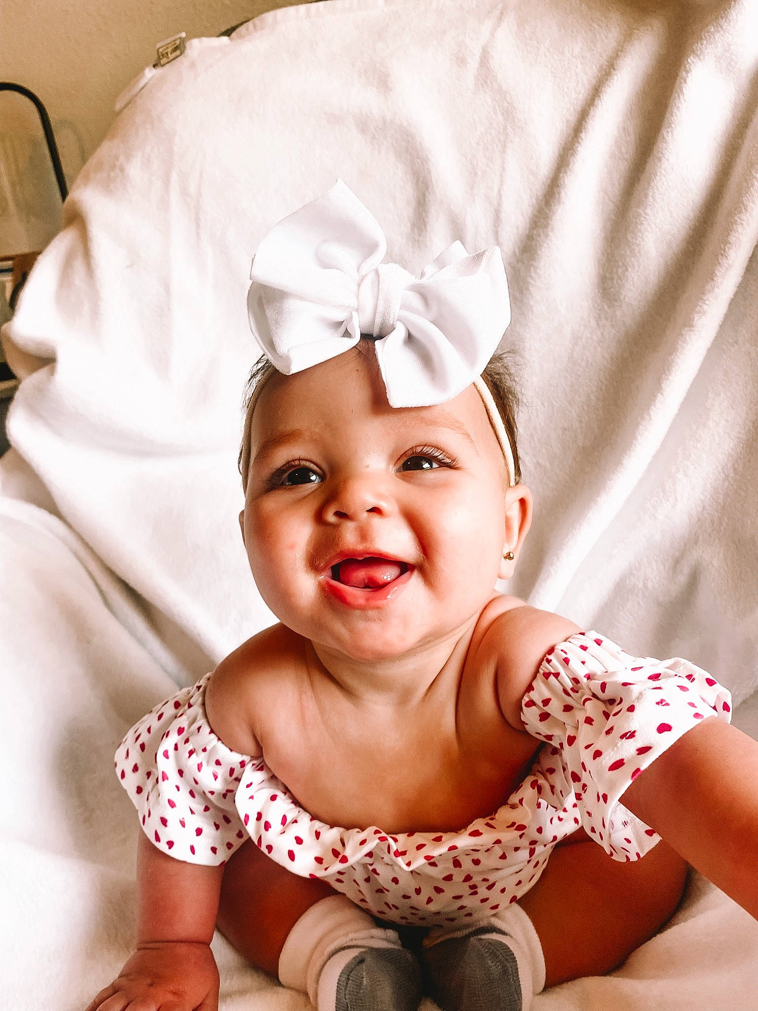 Hayzlee is registered to the contest to win money with this photo: baby, baby_toddler_clothing, child, comfort, event, fashion_accessory, flash_photography, fun, gesture, hair_accessory, happy, head, joy, mouth, person, pink, skin, sleeve, smile, textile