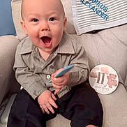 Markus joined the competition — help win amazing prizes! armchair, baby, barefoot, blanket, child, clothing, fabric, face, foot, hand, happy, indoor, milestone_card, pants, person, seated, shirt, smiling, teddy_bear, toy