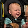 Markus is registered to the contest to win money with this photo: adult_hand, baby, bonding, car_seat, child, closeup, clothing, face, happy, head, indoor, infant, interaction, person, safety, seat, seatbelt, smiling, straps, watch